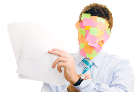 Businessman covered with memos on white background